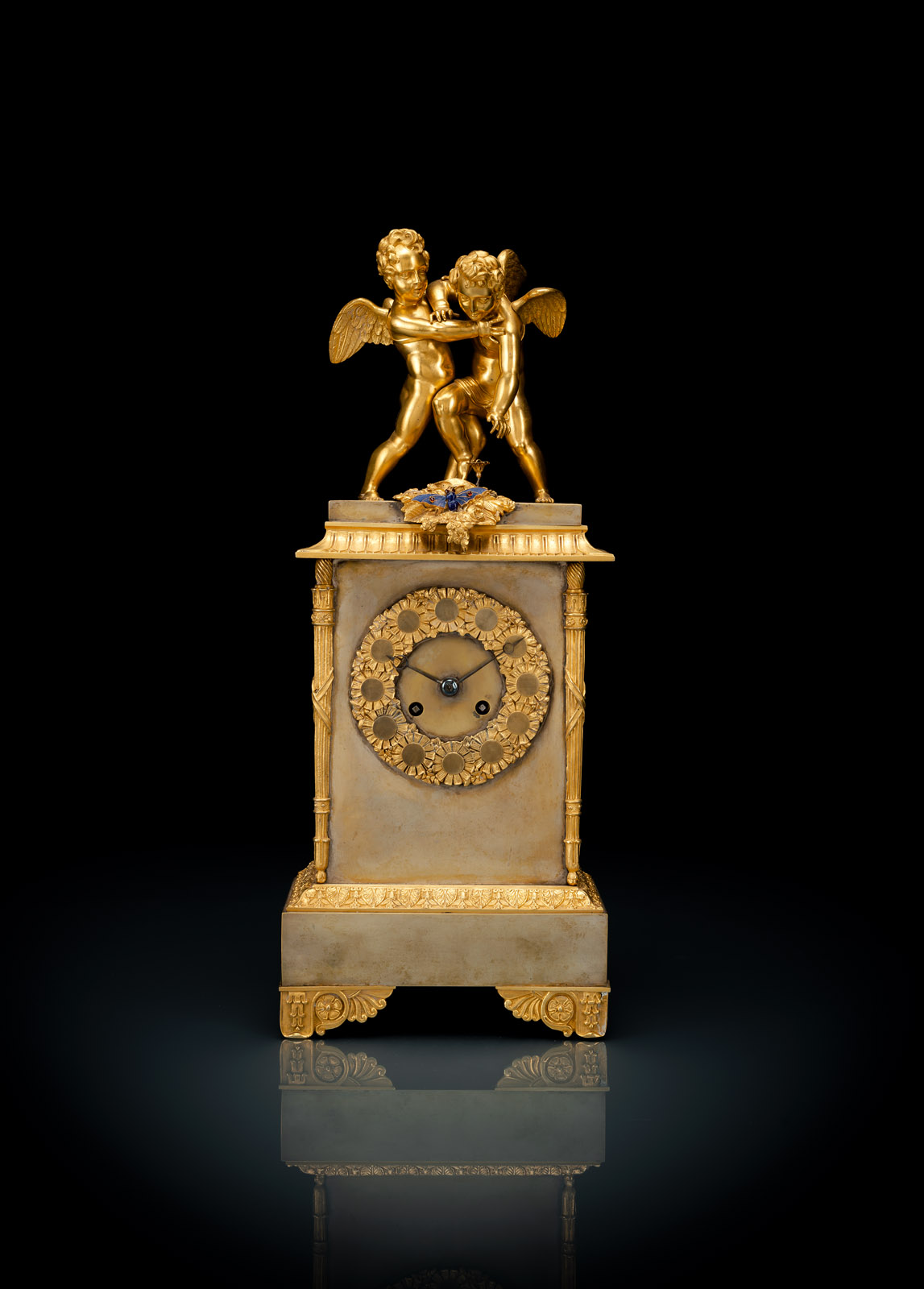 A FRENCH BRONZE EMPIRE PENDULE WITH PUTTI