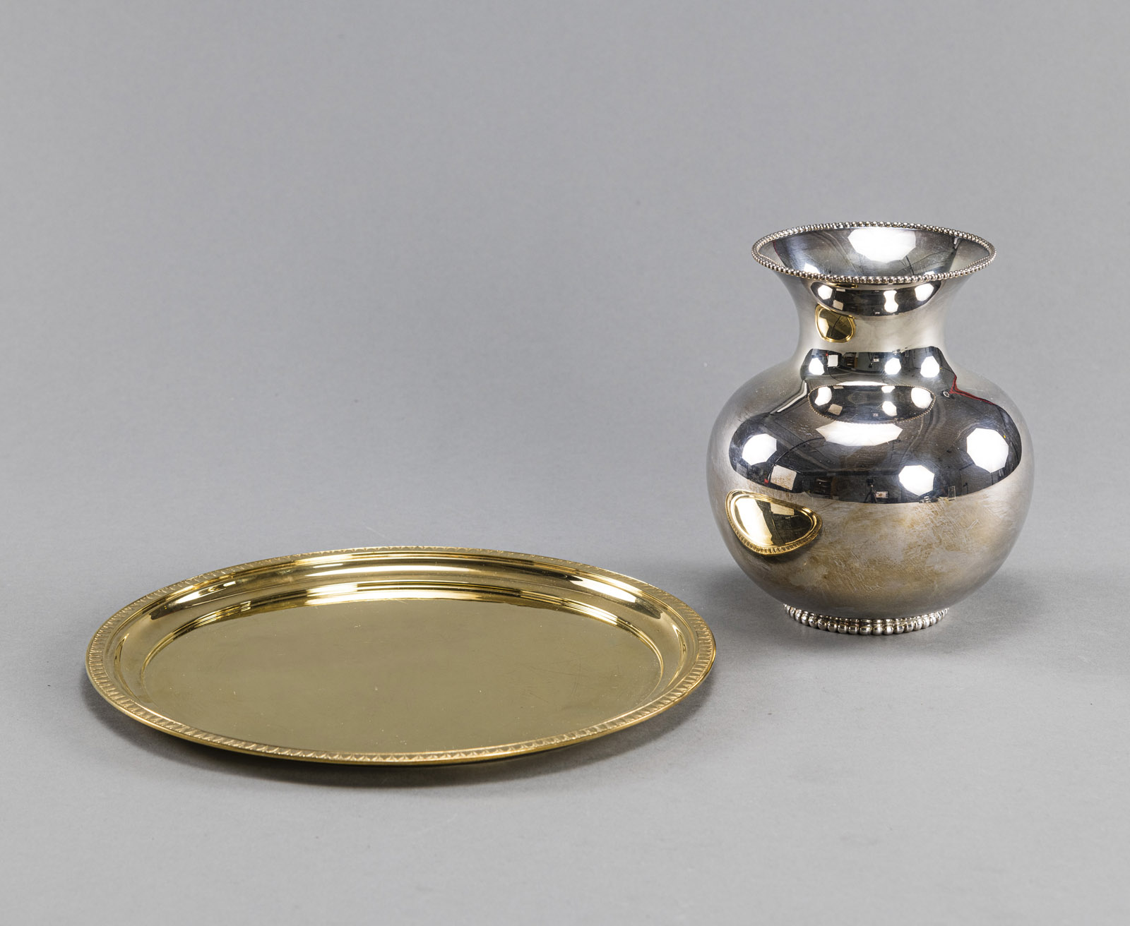 A SILVERGILT TRAY AND A VASE