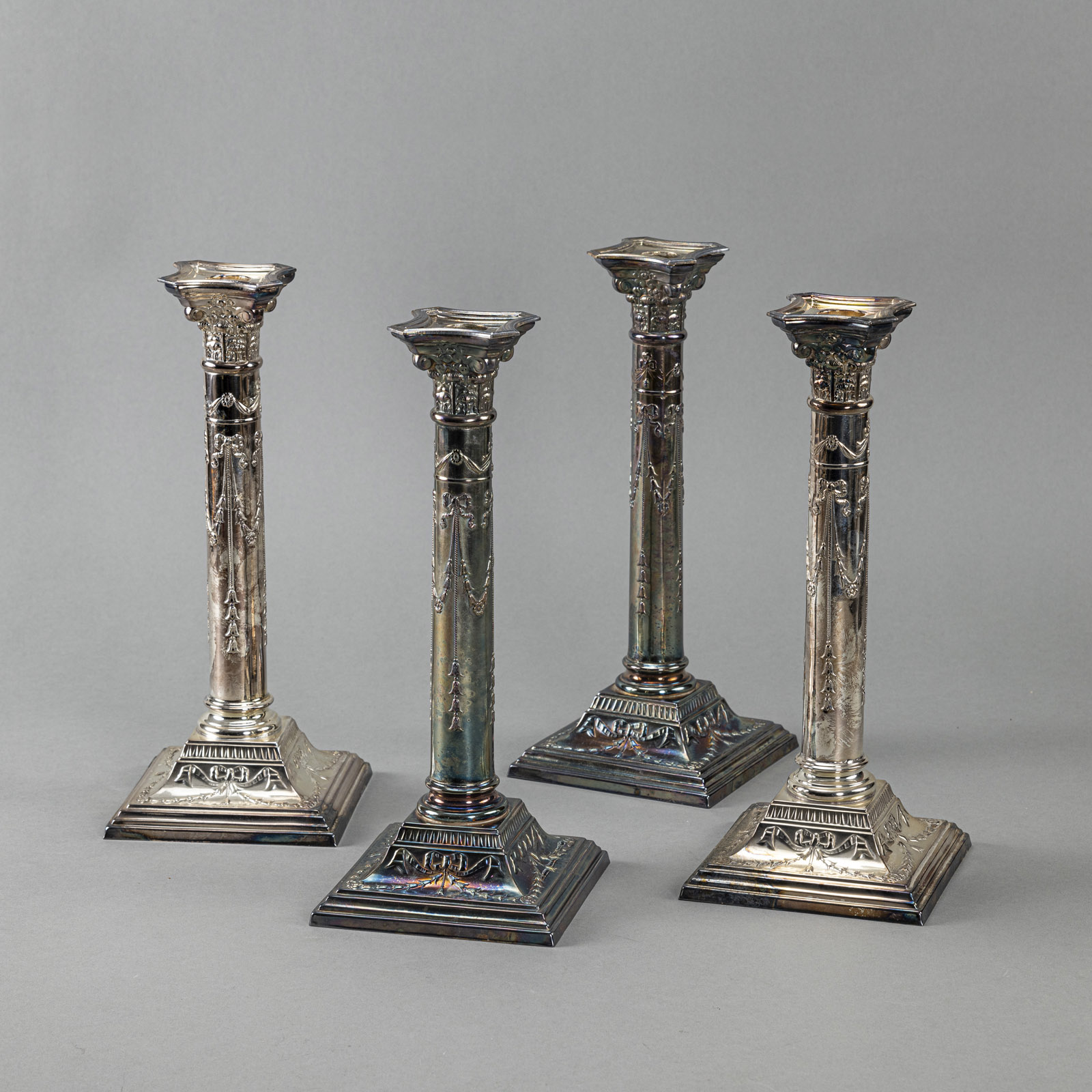 A SET OF FOUR CANDLESTICKS