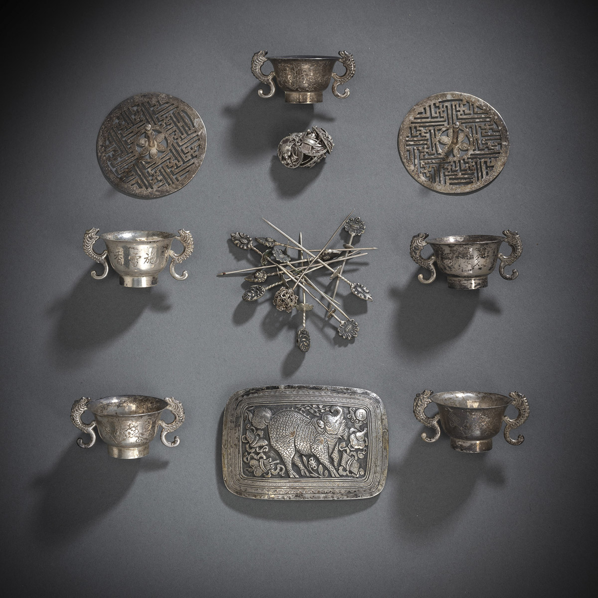 A GROUP OF SILVER WORKS WITH WINE CUPS, KNOBS, A BELT BUCKLE AND SILVER TOOTHPICKS