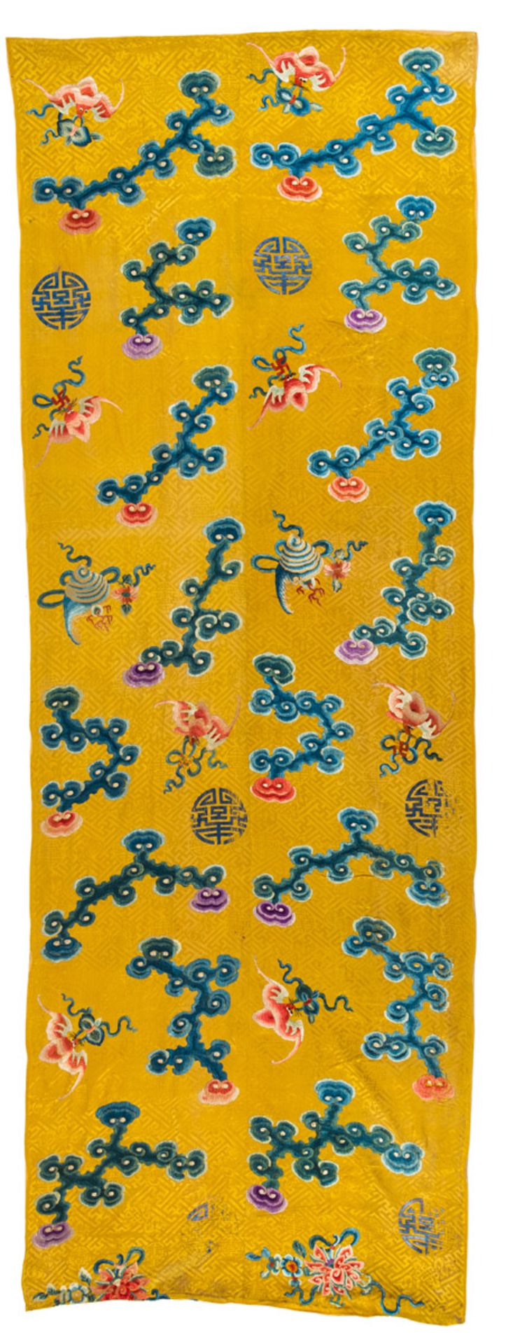 AN IMPERIAL YELLOW-GROUND SILK EMBROIDERED CURTAIN WITH TREASURES, SHOU MEDALLIONS AND CLOUDS