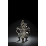 A HEAVY CAST BRONZE TRIPOD LOTUS CENSER WITH PIERCED COVER WITH LION FINIAL