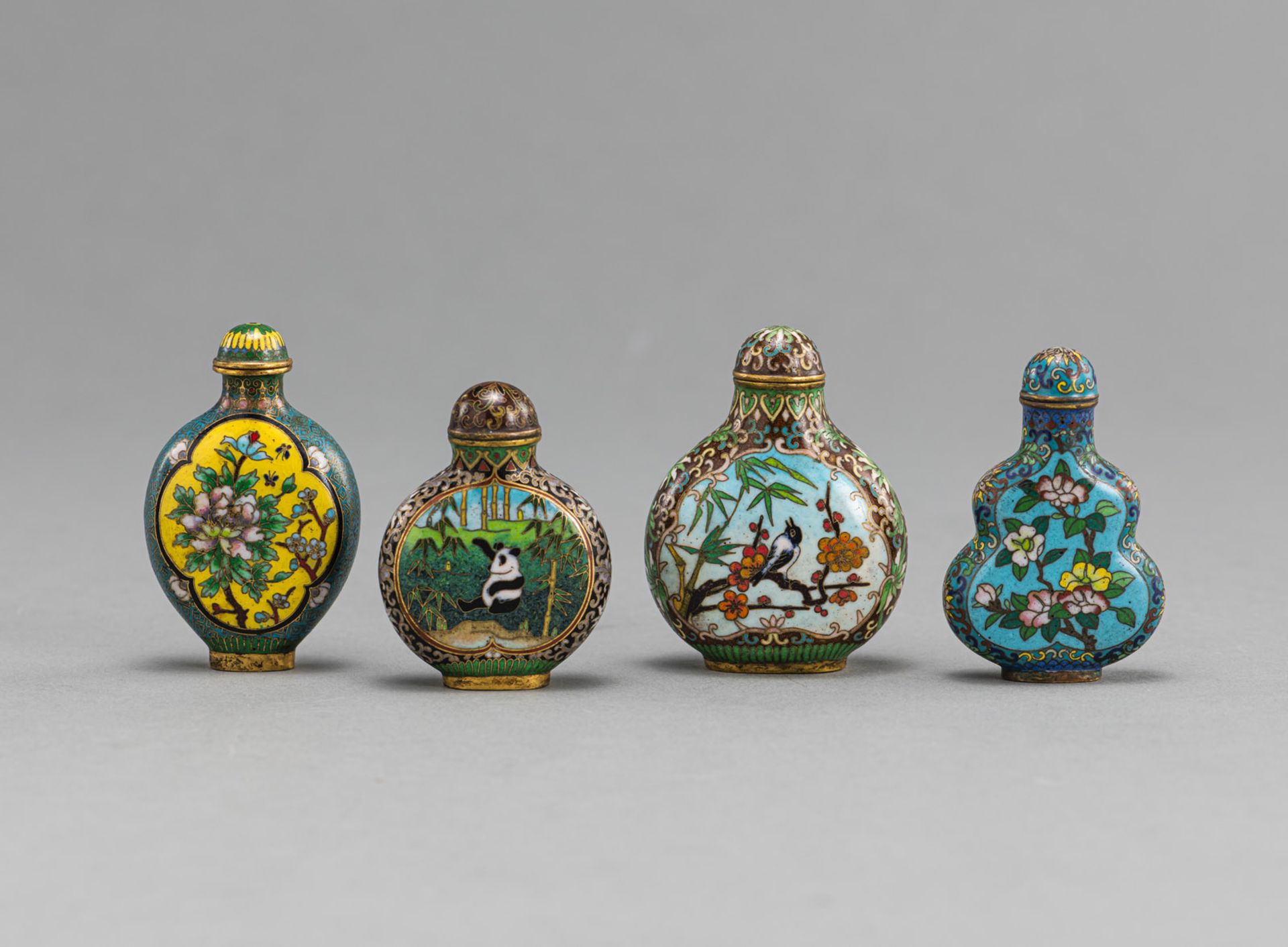 FOUR CLOISONNÉ SNUFFBOTTLES WITH DEPICTIONS OF FLOWERS AND ANIMALS