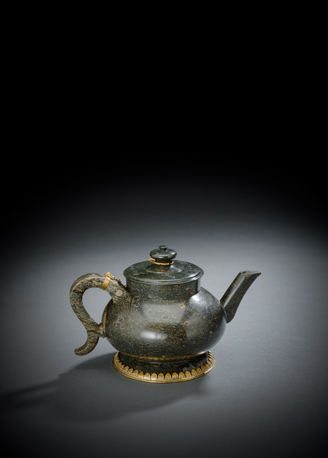 A VERMEIL MOUNTED SERPENTINE TEAPOT AND COVER