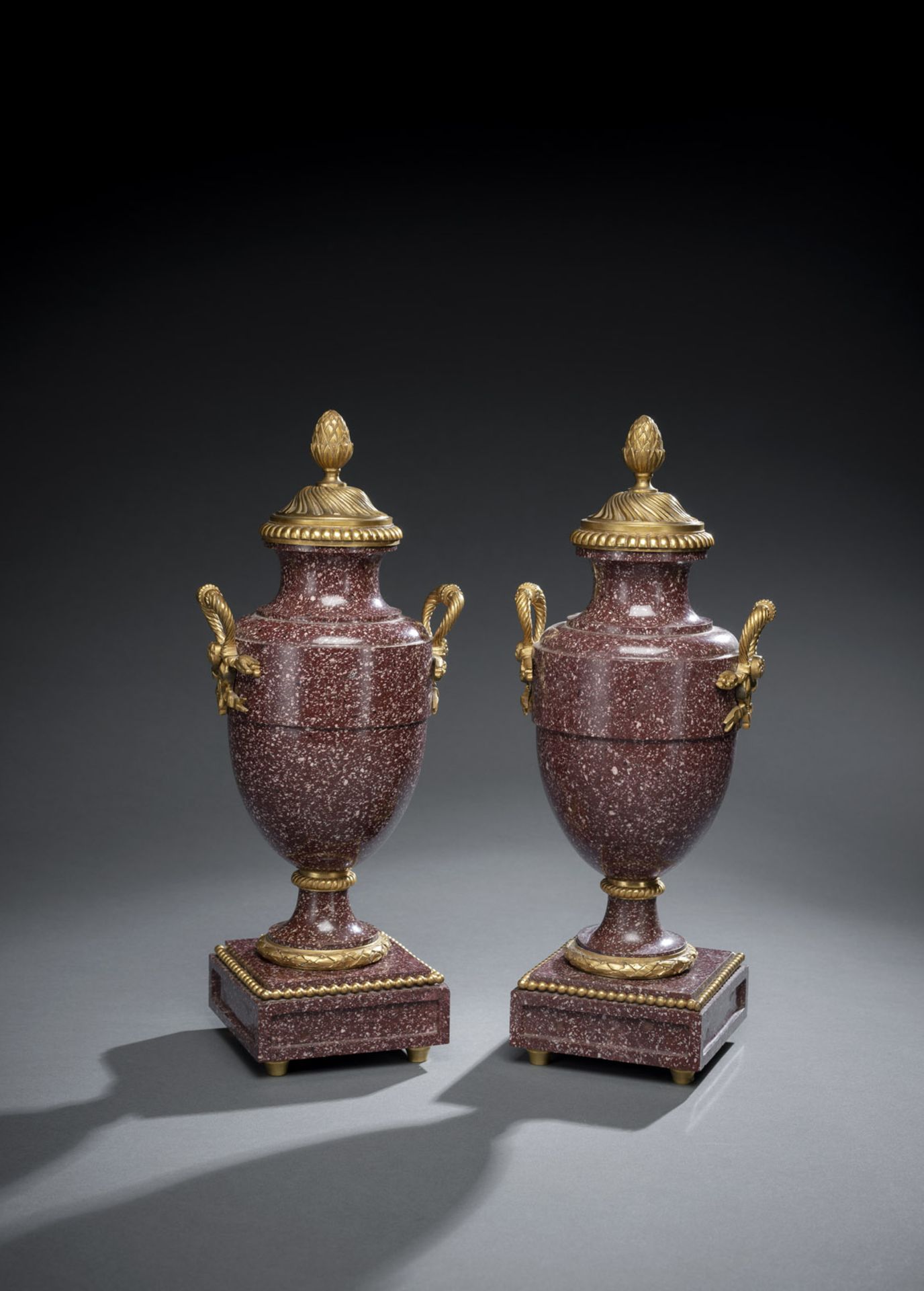A PAIR OF ORMOLU MOUNTED PORPHYRY VASES AND COVERS