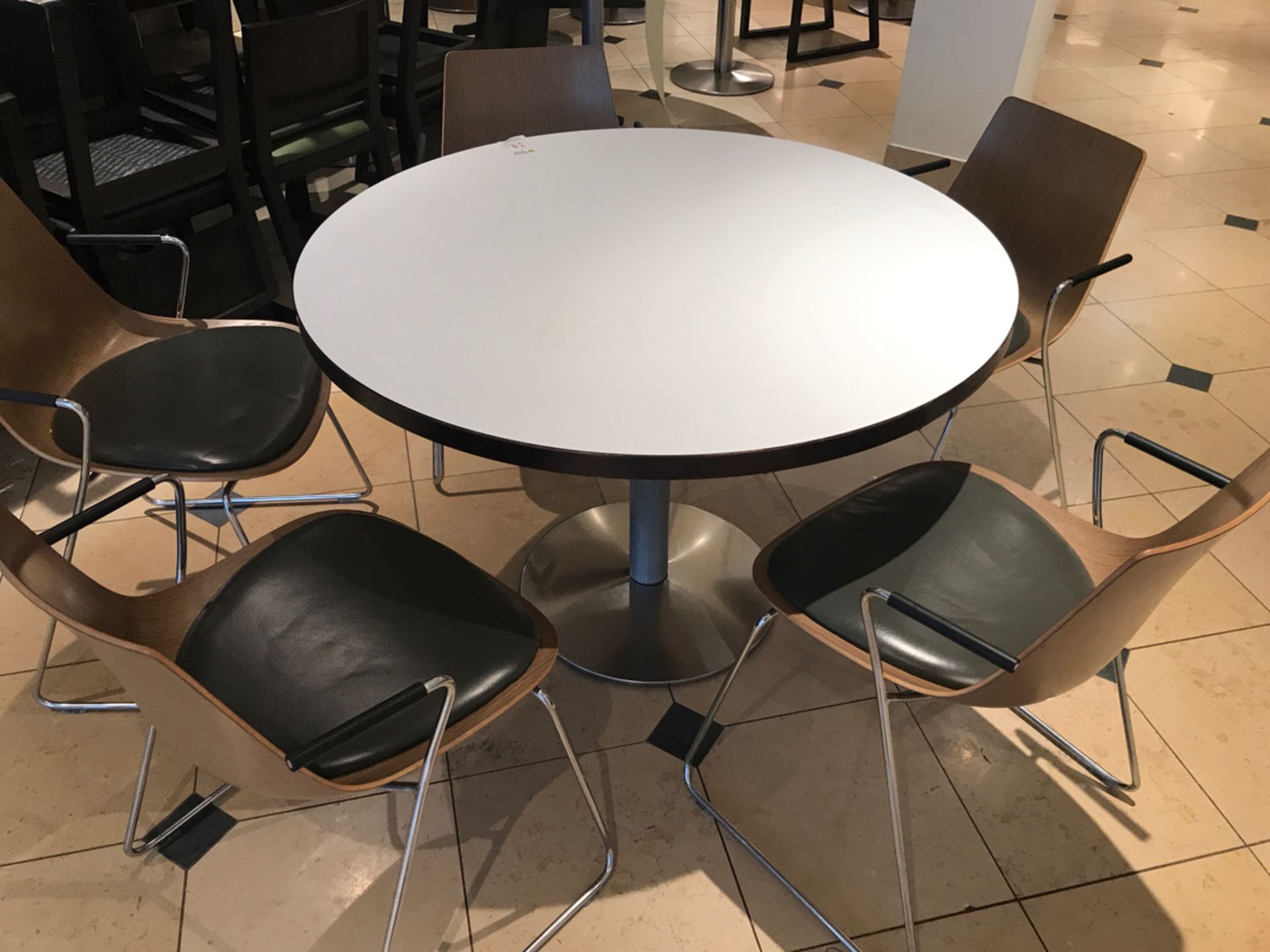 Large pedestal table with five modern designer chairs