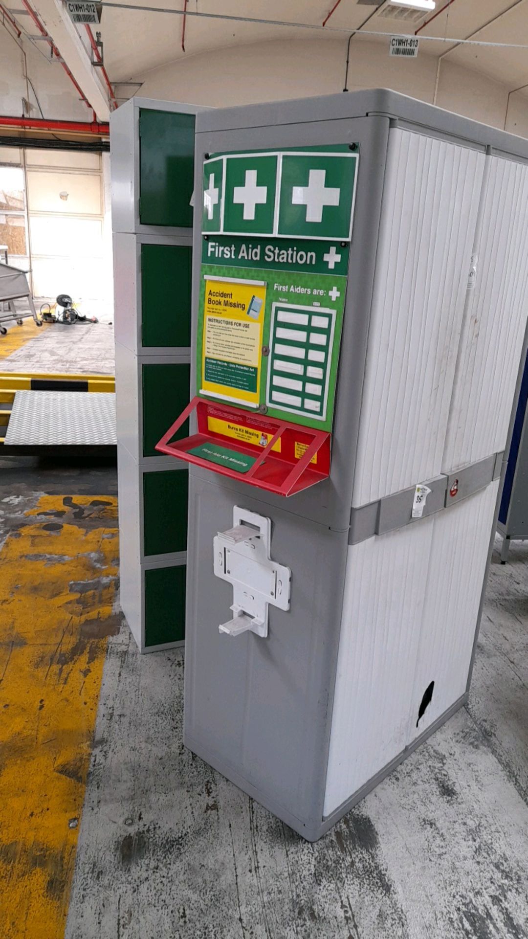 Plastic cabinet with first aid station to side,