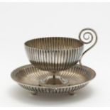 A bouillon cup with saucer