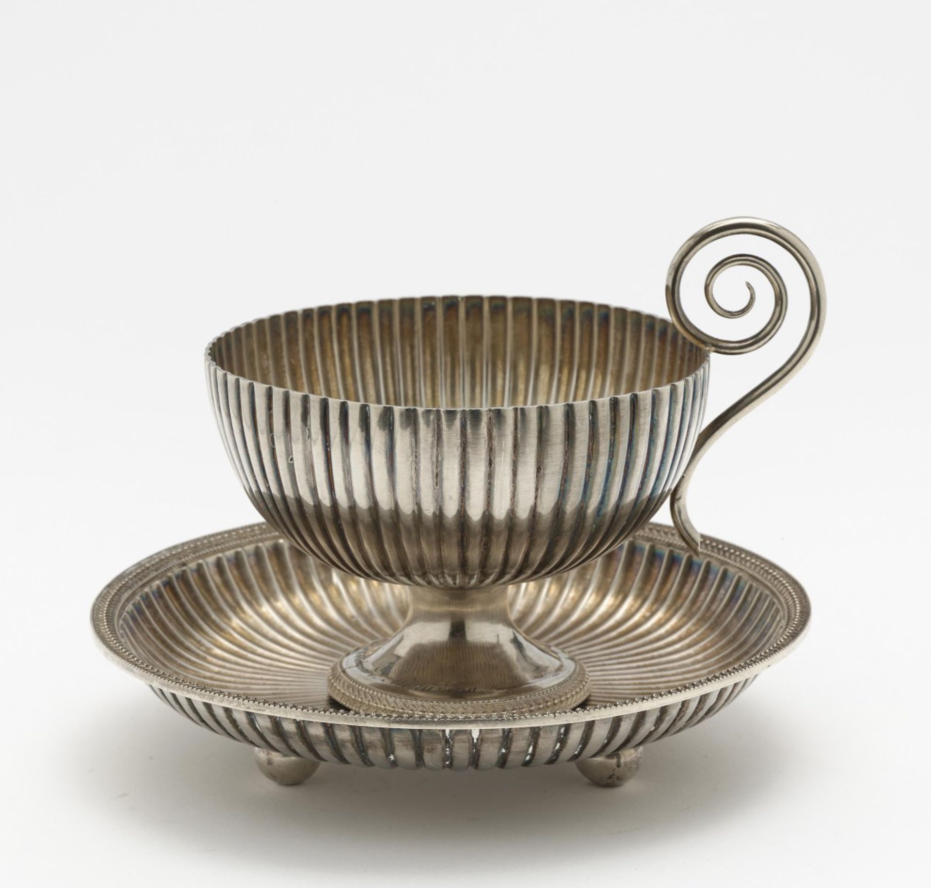 A bouillon cup with saucer