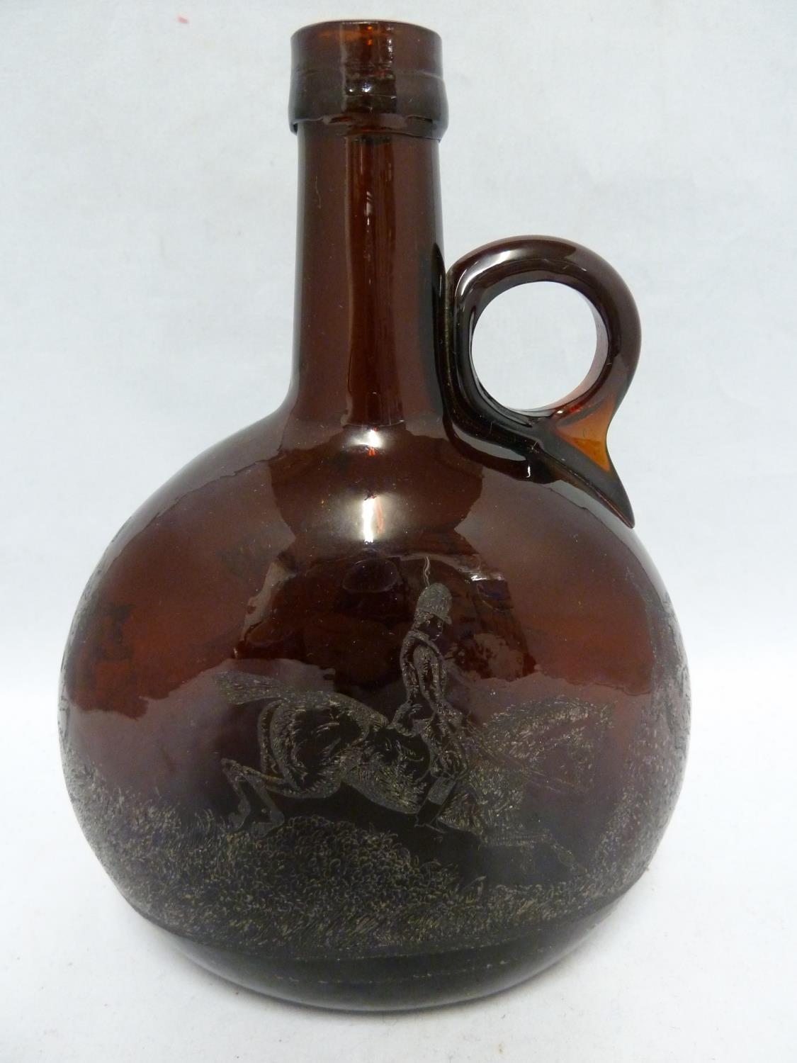 A P Haag, engraver - a 19th Century brown glass finger loop bottle decanter, engraved with a hunting