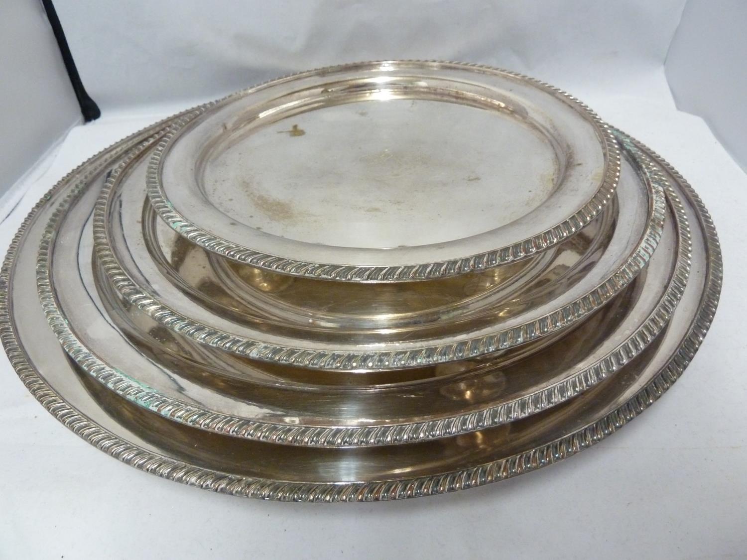 A graduated set of four silver plated salvers, circular with gadrooned edge, the centre engraved - Image 2 of 4
