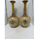 A large pair of Doulton Slaters patent bottle vases, decorated by Bessie Newbery, decorated in