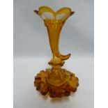 Bohemian - an unusual amber cased glass perfume bottle of cornucopia form, the rim cut with