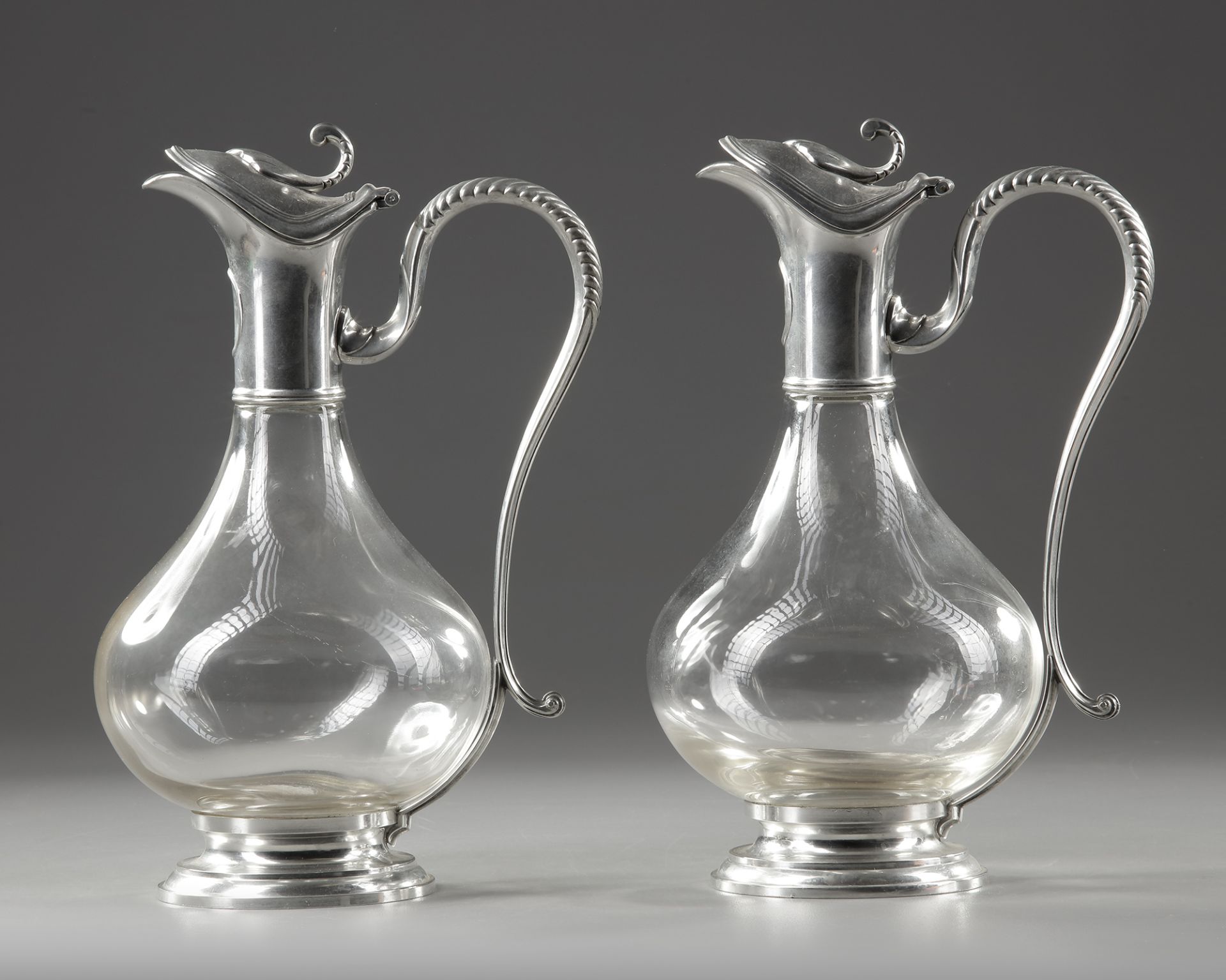 A PAIR OF CRYSTAL AND SILVER METAL EWERS, LATE 19TH CENTURY