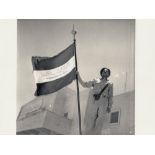 A RARE PHOTOGRAPH OF A PROUD STANDING SAUDI SOLDIER HOLDING AN UNIQUE SAUDI ARABIA FLAG, PROBABLY 19