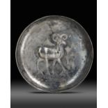 A SILVER DISH WITH THE IMAGE OF A RAM, LATE SASSANIAN OR EARLY ISLAMIC, CIRCA 7TH CENTURY