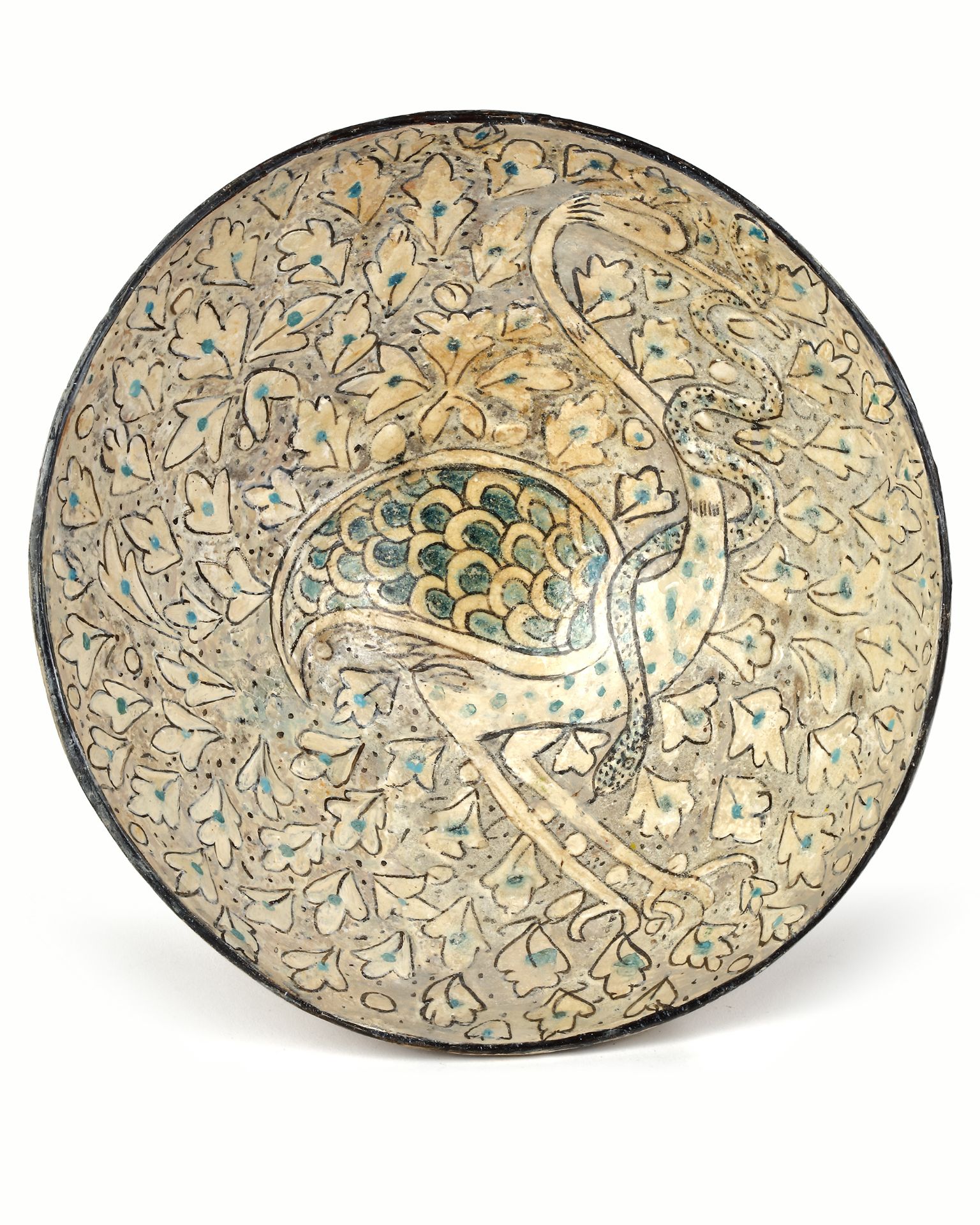 AN ISLAMIC BOWL DEPICTING A BIRD, SULTANABAD WARE, 12TH-13TH CENTURY