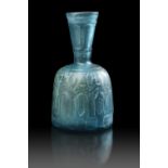 A FINE PALE BLUE CUT GLASS BOTTLE WITH FUNNEL NECK, PERSIA, 10TH-11TH CENTURY