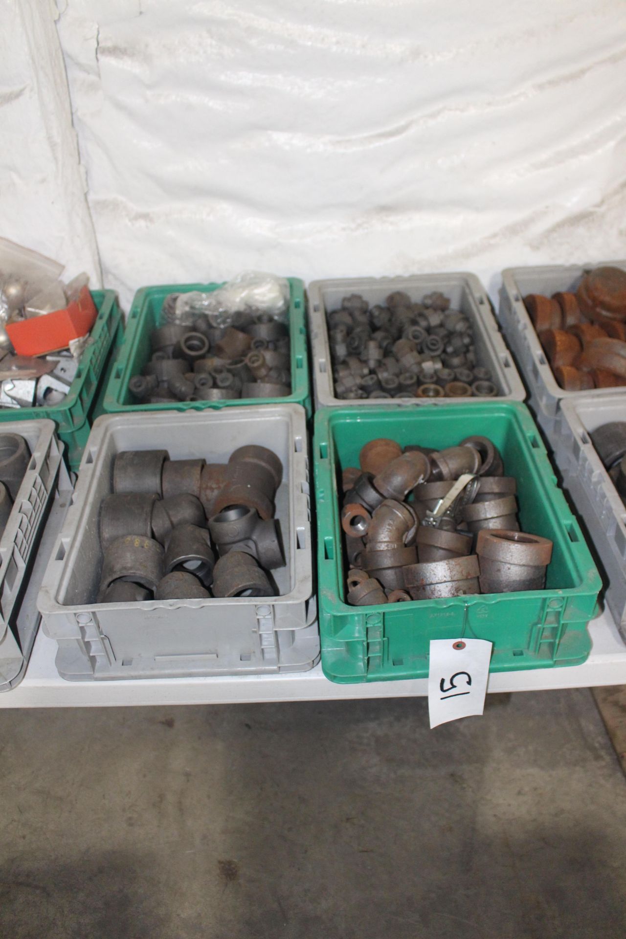 Four Bins of Steel Pipe Fittings