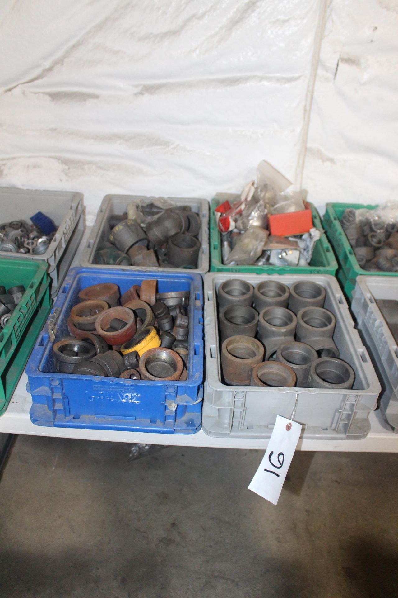 Four Bins of Steel Pipe Fittings