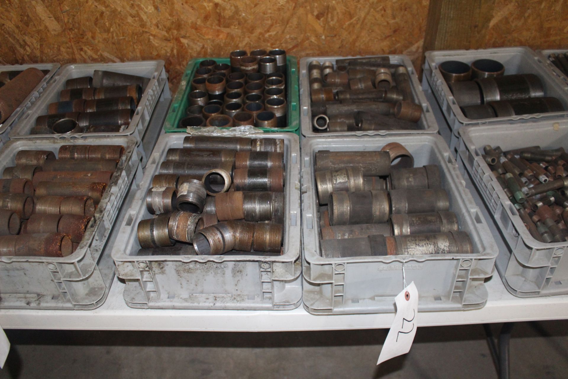 Four Bins of Steel Pipe Fittings