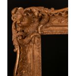 20th Century English School. A Carved Giltwood Frame, with swept and pierced centres and corners,