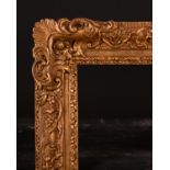 Late 19th Century English School. A Carved Giltwood Frame with swept and pierced centres and