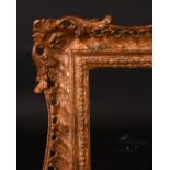 20th Century English School. A Gilt Composition frame with swept and pierced centres and corners,