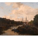 Johann Hendrik van Mastenbroek (1875-1945) Dutch. A Canal Scene in Amsterdam, with a Figure