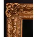 20th Century English School. A Gilt Composition Frame with swept and pierced centres and corners,