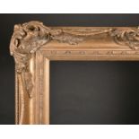 20th Century English School. A Gilt Composition Frame, with swept and pierced centres and corners,