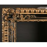 19th Italian School. A Gilt and Black Painted Composition Frame, rebate 55” x 27.5” (139.7 x 70cm)