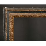 17th Century Italian School. A Carved Giltwood Frame, with Black Panels, rebate 28.25” x 18.5” (71.8
