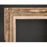 20th Century French School. A Gilt Composition Louis Style Frame, with swept corners, rebate 30.5" x