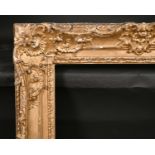 19th Century English School. A Carved Giltwood Frame, with swept centres and corners, rebate 27.5” x