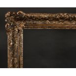 20th Century English School. A Gilt and Painted Composition Frame, with swept centres and corners,