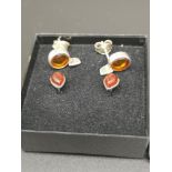 Pair of silver earrings set in Amber together with others.