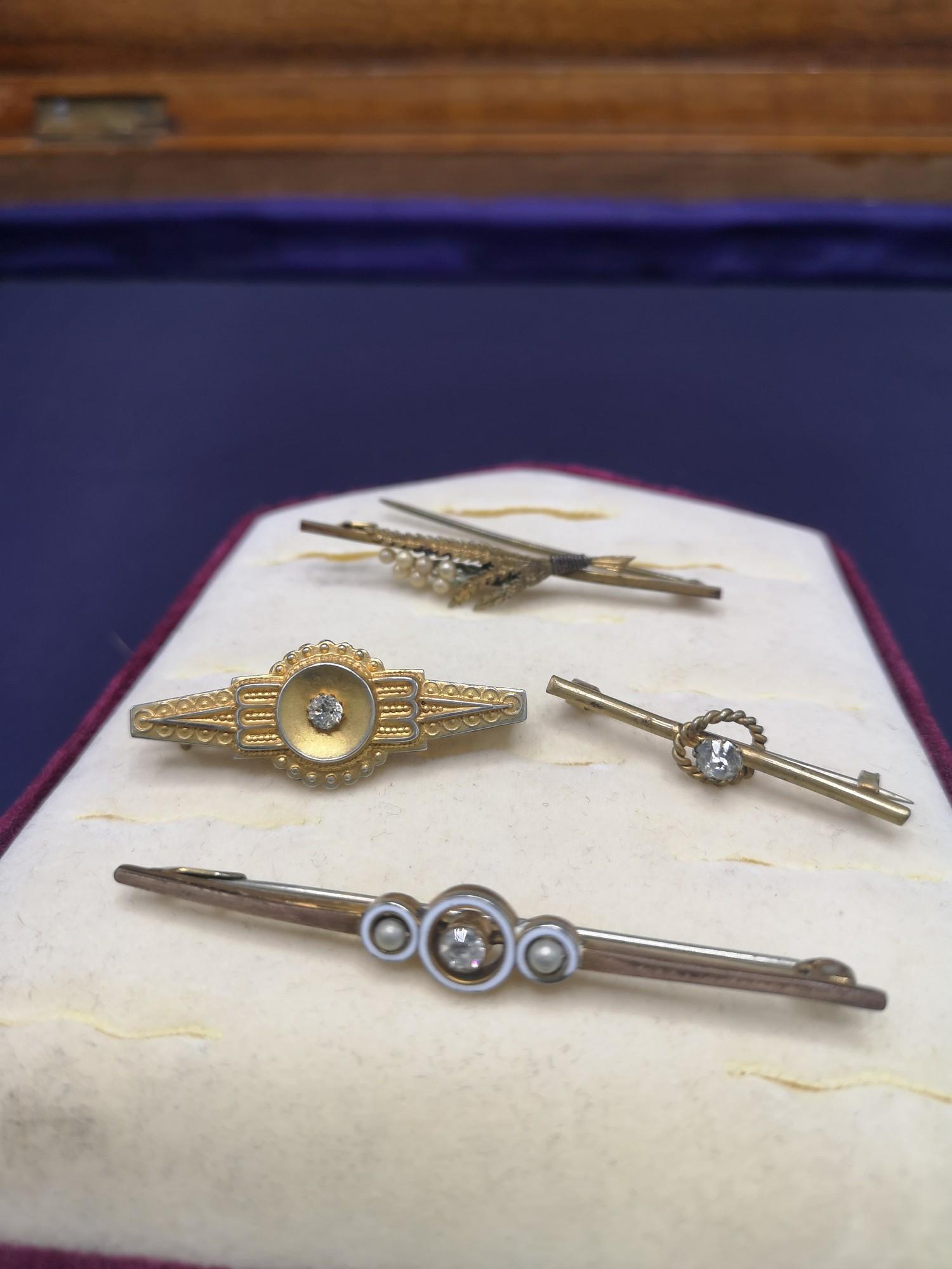 4 yellow metal bar brooches no Hall marks.