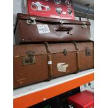 Large travel trunk with wooden bounding together with vintage suit case.