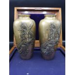 Pair of bronze early Chinese vases with dragon foliage.