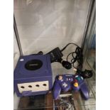 Nintendo game cube with controller.