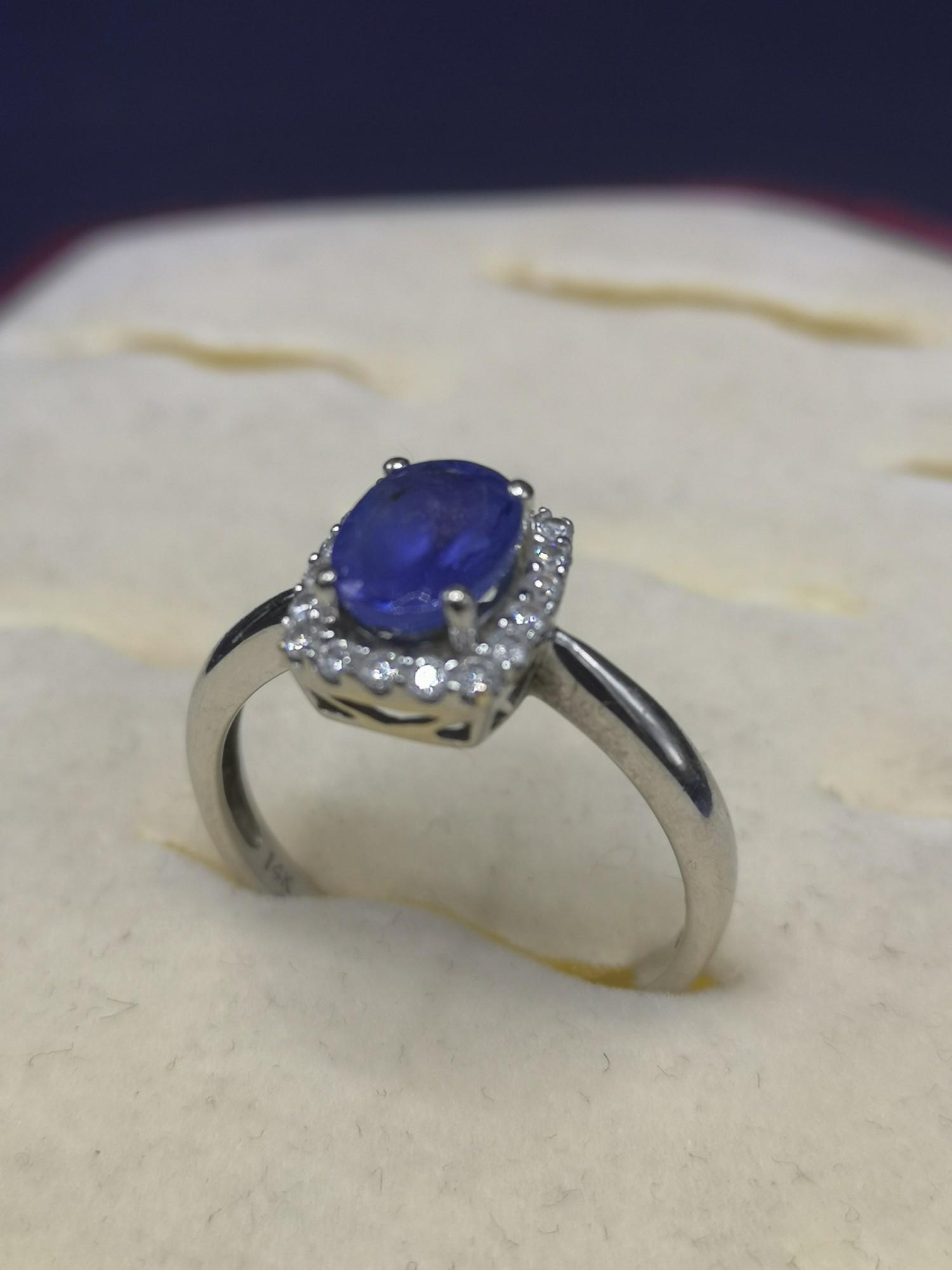 14kt white gold diamond and blue stone ring. 3.3 grams.