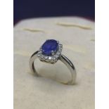 14kt white gold diamond and blue stone ring. 3.3 grams.