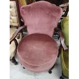 Antique 1900s nursing arm chair with wooden supports.