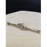 9ct gold victorian bar brooch set in green stone with pearls to side.