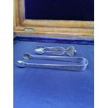 Pair of sterling silver Oriental tongs together with pair of silver fillagree tongs.