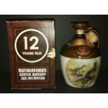 Rutherfords whisky decanter full with box.