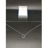 Silver chain set with decorative pendant.