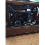Antique singer sewing machine in fitted casing.