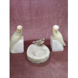 Cold painted bird figure sat on base together with pair of onyx bird figures.